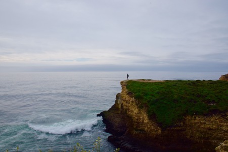 Standing on the edge of the world on a sea cliff above the ocean