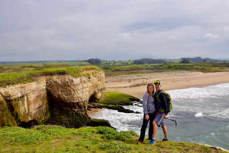 Couple enjoying the ocean and sea cliffs after a hike