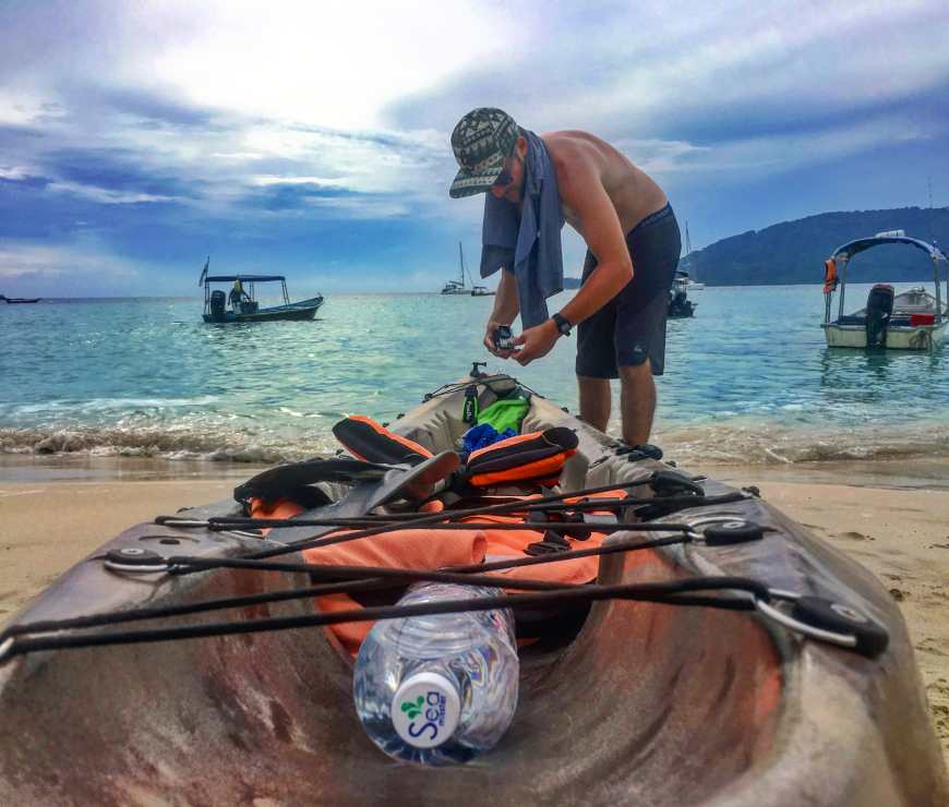Checking our kayak and getting ready for to paddle around the island of Perhentian Kecil