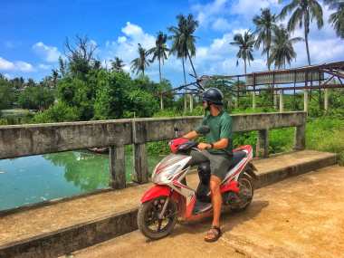 Taking our motorbike out for a spin to Explore the island of Koh Lanta in Southern Thailand on a sunny day