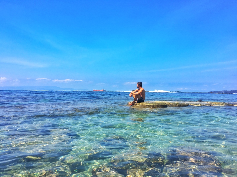 Sitting in the middle of the blue ocean in Candidasa Bali